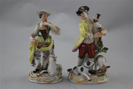 A pair of Meissen groups of a musical shepherd and shepherdess, 20th century, 16cm. and 15cm., minor losses to leaves